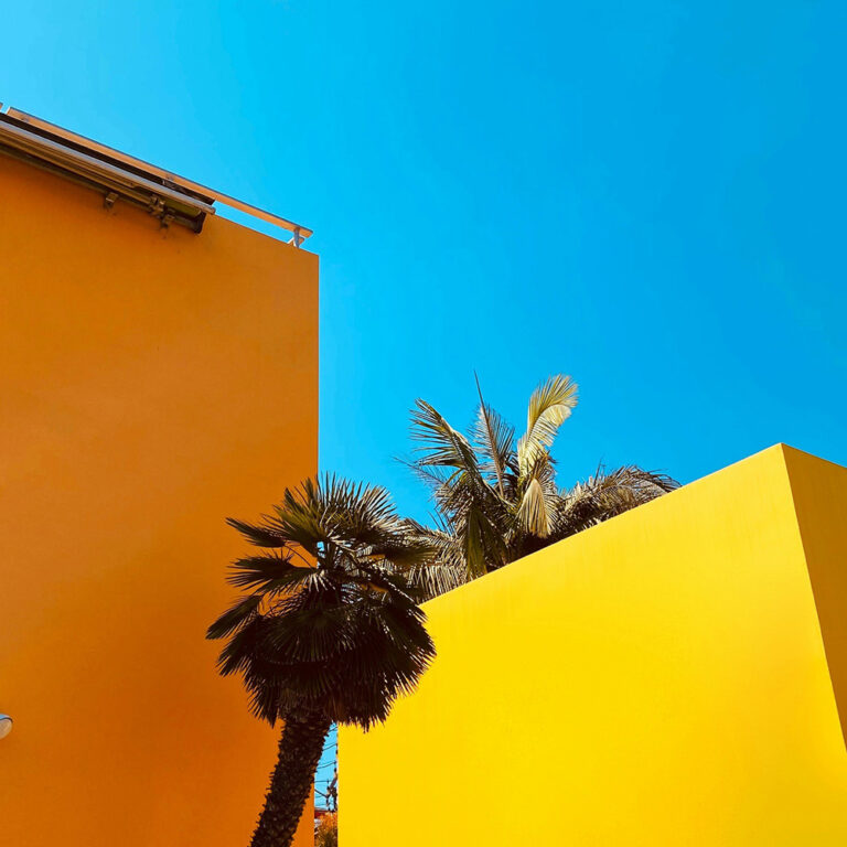 イエローとオレンジの建物よ青空